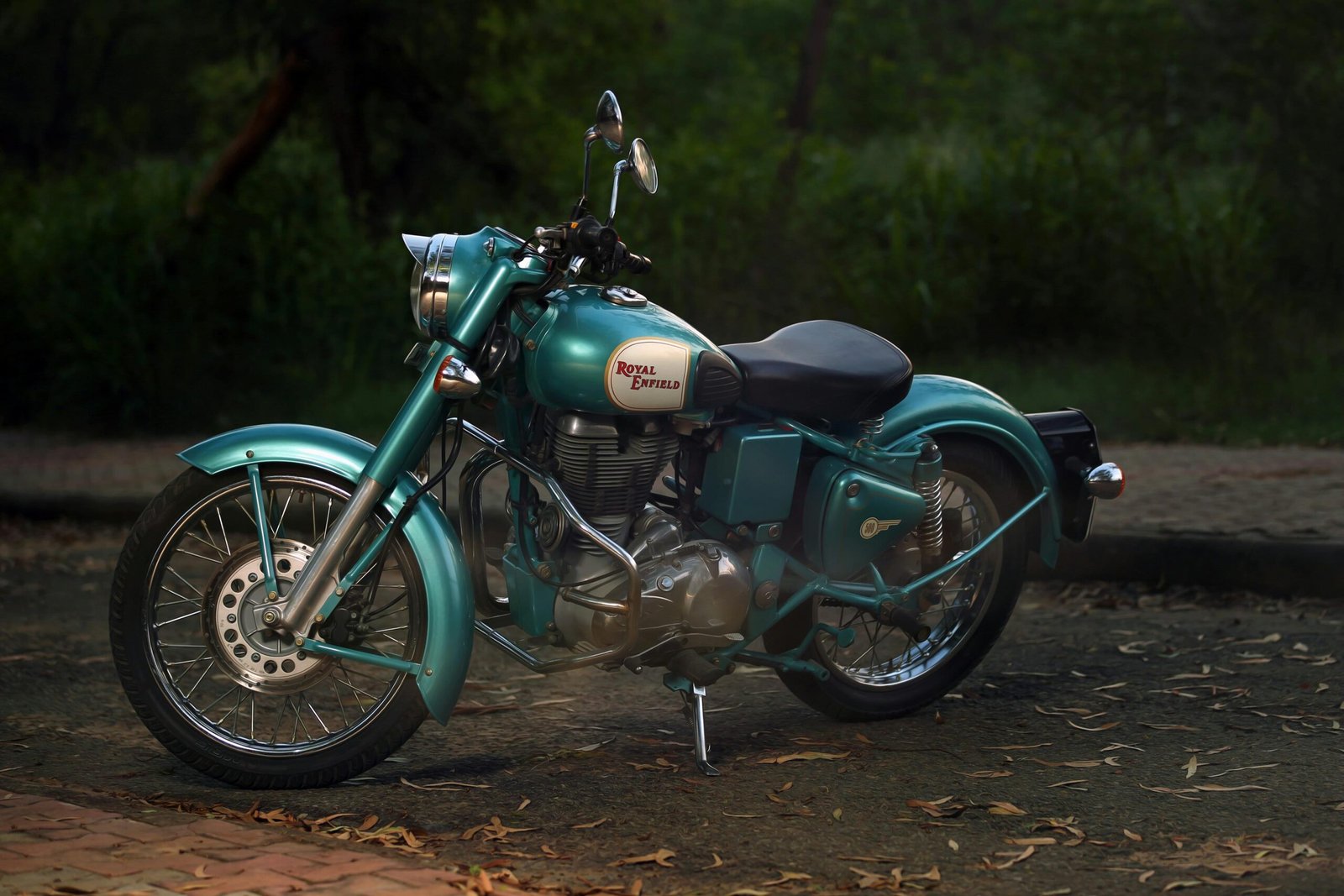 Classic Royal Enfield motorcycle parked peacefully in an outdoor setting, representing vintage style and timeless engineering.